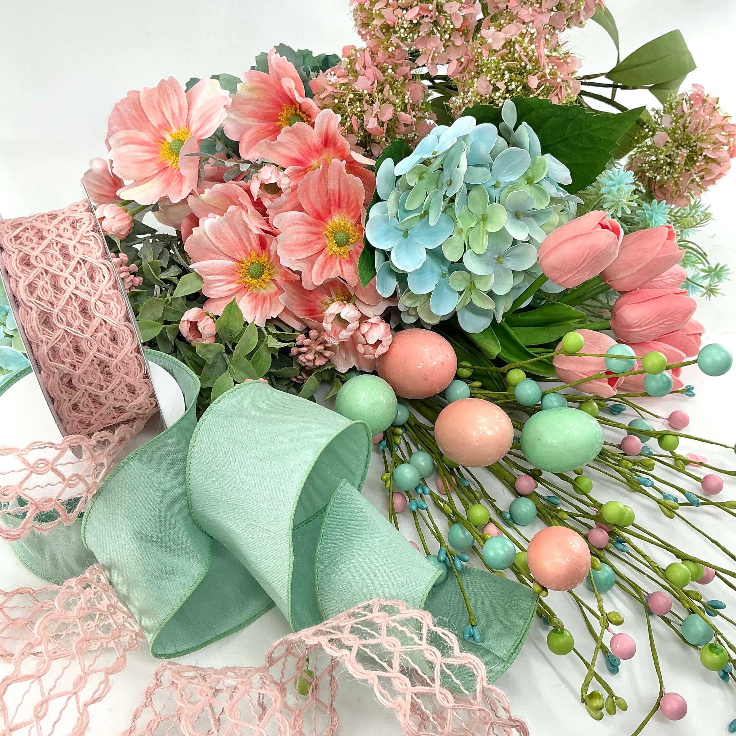 ribbons and artificial flowers in pastel blues, greens, and pinks