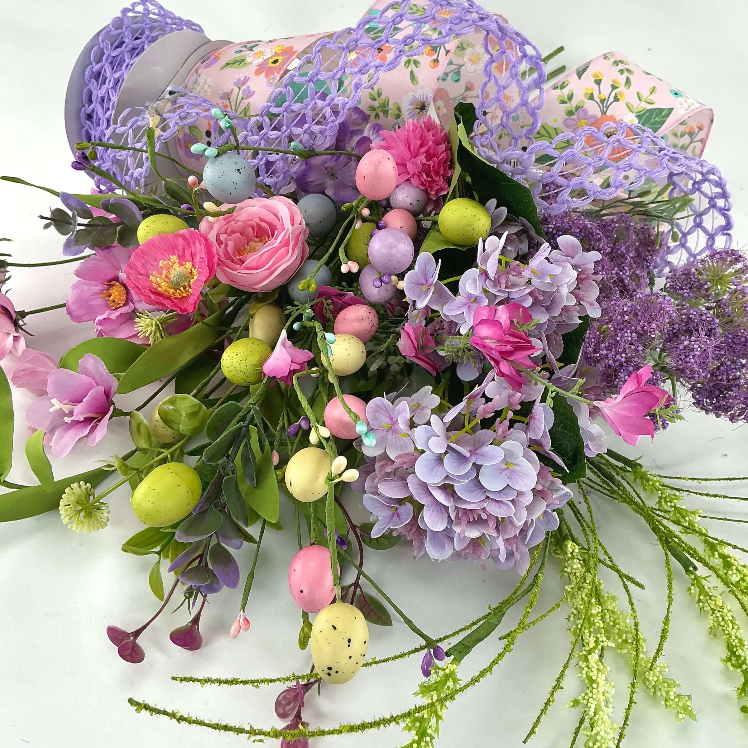 ribbons, faux flowers, and sprays in purples, pinks, greens, and yellows