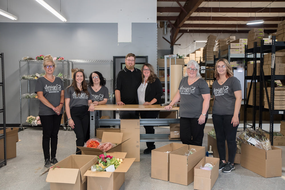 greenery market team posing in the warehouse with the owners