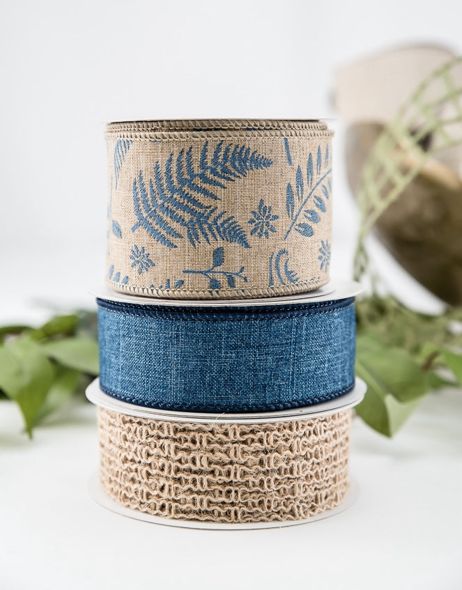 denim and burlap ribbon rolls stacked  on top of each other